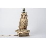 An early 20th Century plaster lamp base in the form on an owl, with orange glass eyes, height of