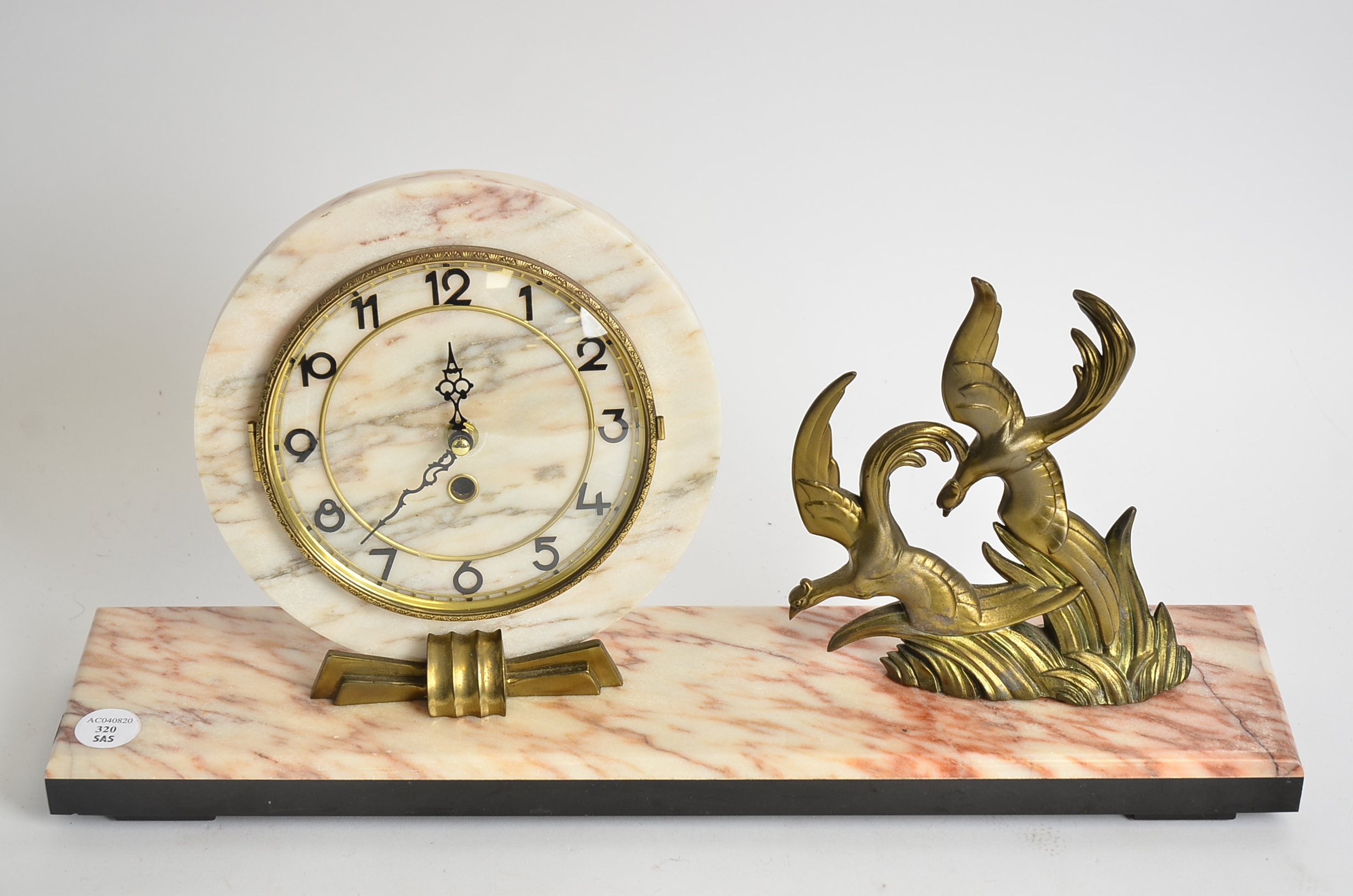 A French Art Deco circular clock, on a coloured marble base, with cast metal decoration of birds