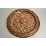 A mid 19th Century copper charger, The Battle of the Amazons', the central roundel with nude
