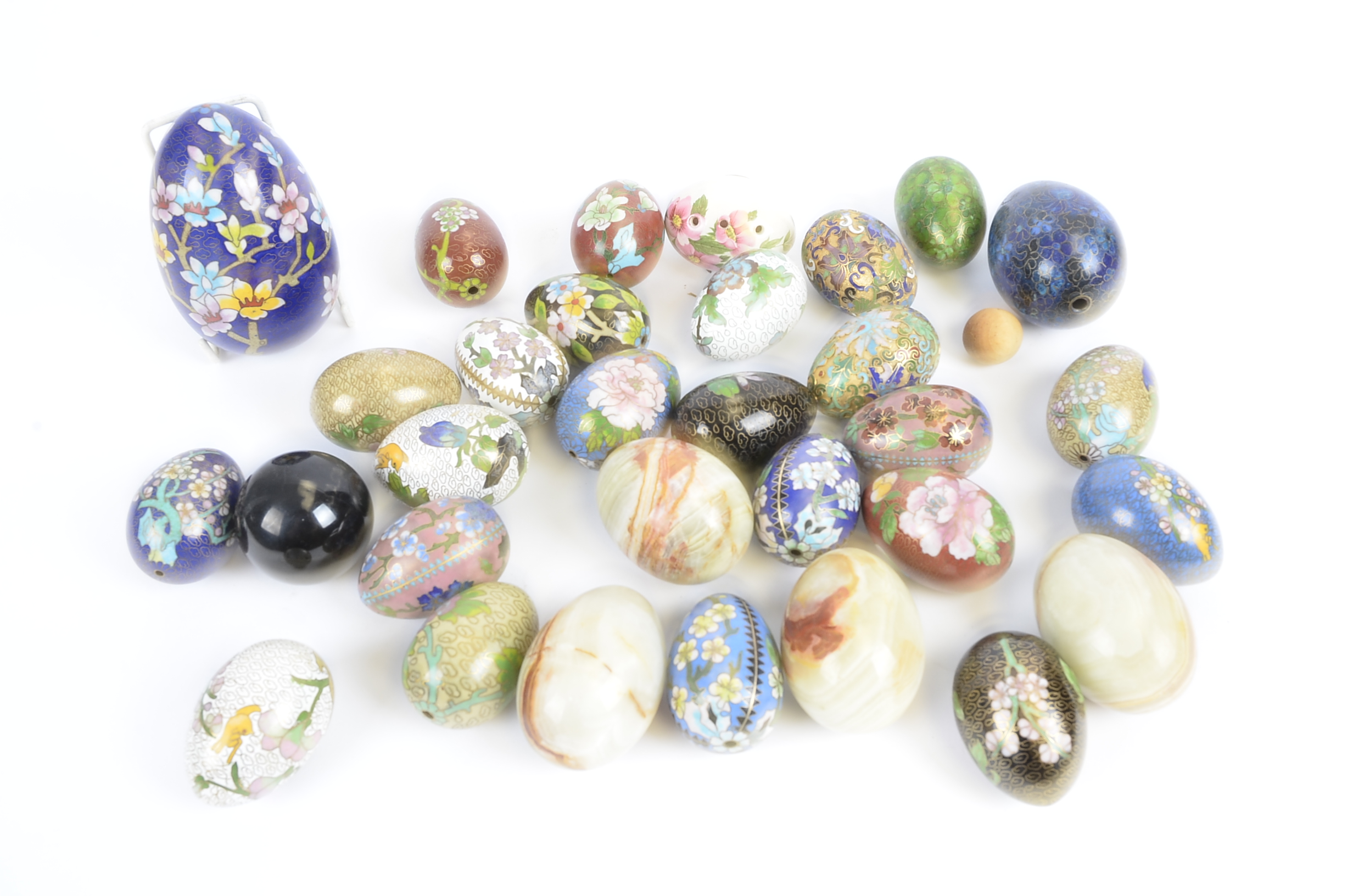 A collection of eggs, to include cloisonné and alabaster examples, (25+)