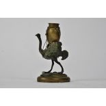 A late 19th Century Bergman style bronze and base metal figure of an ostrich, carrying a vessel on