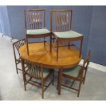 A mid-century teak dining suit, possible Danish design, comprising of an oval draw leaf table with