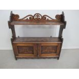 A 19th century pokerwork hanging wall cupboard, double door below two shelfs, shaped sides and