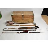 A early 20th Century small pine campaign style trunk, together with a shooting stick and