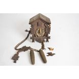 A 20th Century Continental cuckoo clock, with weights, 18cm x 13cm