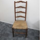 A late 19th century rush seated ladder back chair , oak and elm, turned front stretcher and supports