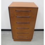 A mid-century teak G plan Fresco tall boy chest, with six long drawers on plinth base, makers