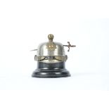A late 19th Century French helmet inkwell, with sword piercing through, height 8cm, a/f finial