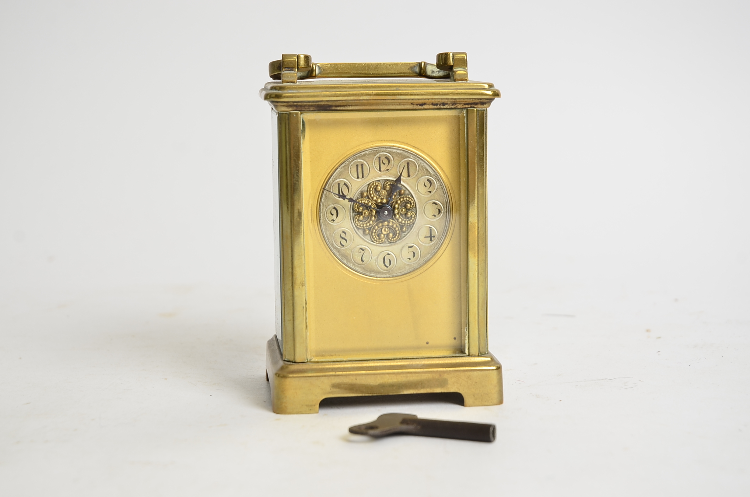 A brass carriage timepiece, the dial with Arabic numerals and decorative central panel, height - Image 2 of 2