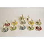 A harlequin group of Continental porcelain cups and saucers, with gilt handles and transfer