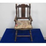A late 19th century stained beech childs arm chair, with turned arms and supports, loose cushion