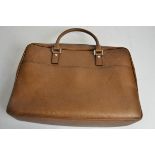 A Salvatore Ferragamo designer handbag, of tanned textured leather, with brown monogrammed interior,