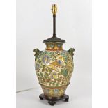 A Portuguese maiolica style table lamp, decorated with birds and foliage and twin handles in the