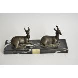 An Art Deco onyx and spelter centrepiece, modelled as a pair of seated deer, signed to marble,
