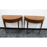 A pair of George III Sheraton style demilune satinwood card tables, the tops having boxwood and