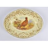 A 19th Century Royal Worcester oval plate, painted with a study of a pheasant with a gilt