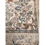 A woollen carpet, with central section of interspersed woodland animals, with a rectangular surround