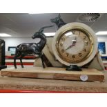 A French Art Deco mantel clock, in cream and brown marble, circular brass face with Arabic