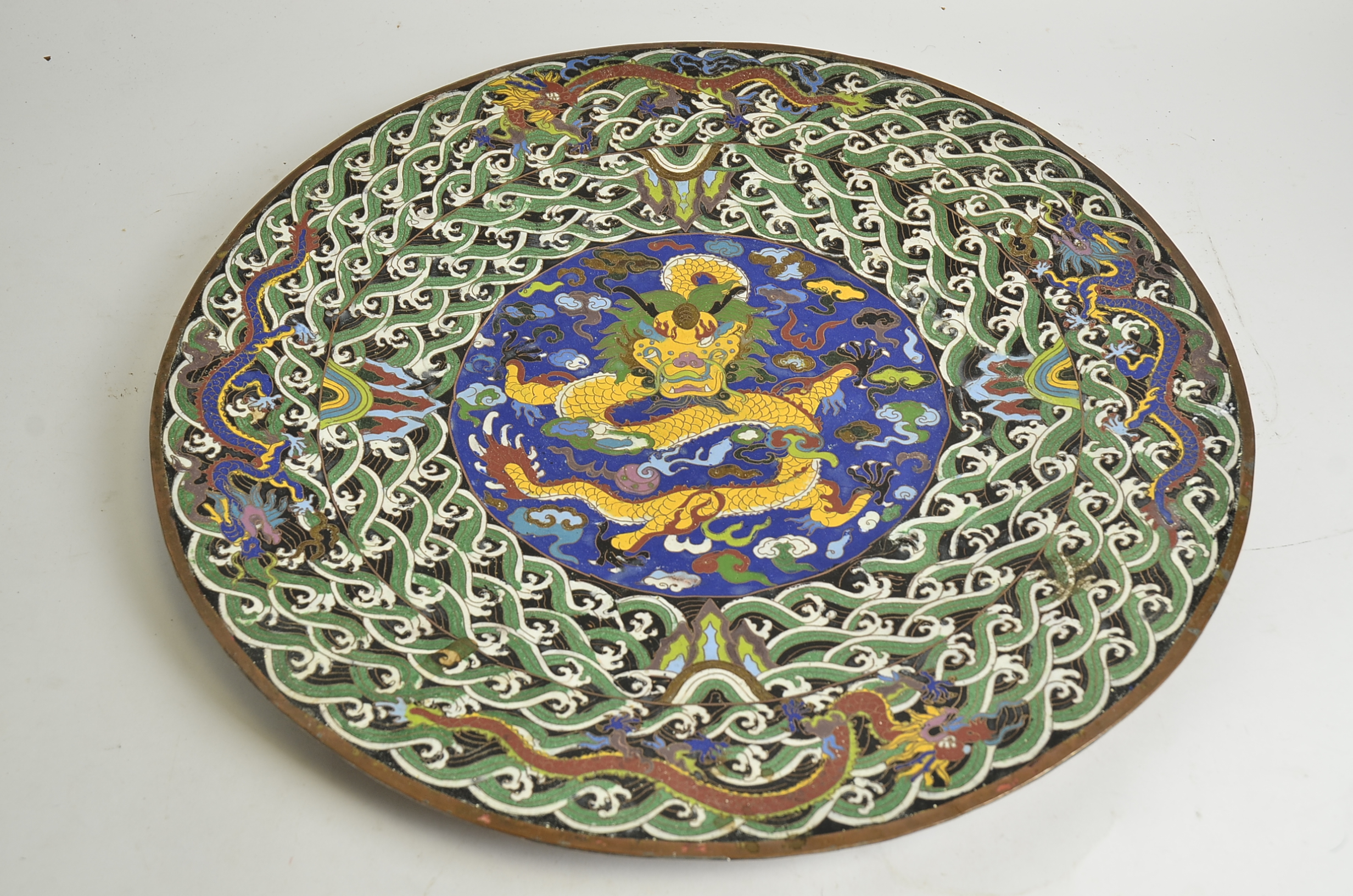 A Cloisonné charger of substantial proportions, with dragon and flaming pearl decoration, the