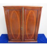 An Edwardian mahogany inlayed two door wall cupboard, with boxwood and satinwood banding, oval