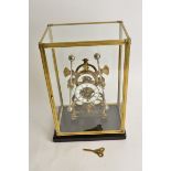 A large brass skeleton double pendulum 'Grasshopper' clock, the central enamel dial with Roman