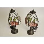 A pair of contemporary Tiffany style stained glass topped table light bases, rising from organic