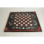 A 20th Century lacquered and mother of pearl Chinese chess and backgammon board, 63cm x 28cm x