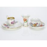 A Meissen porcelain trio, the cup, saucer and side plate with floral spray decoration painted in