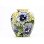 A contemporary Jonathan Cox ovoid vase, decorated with tubelined pansies, in blue with yellow
