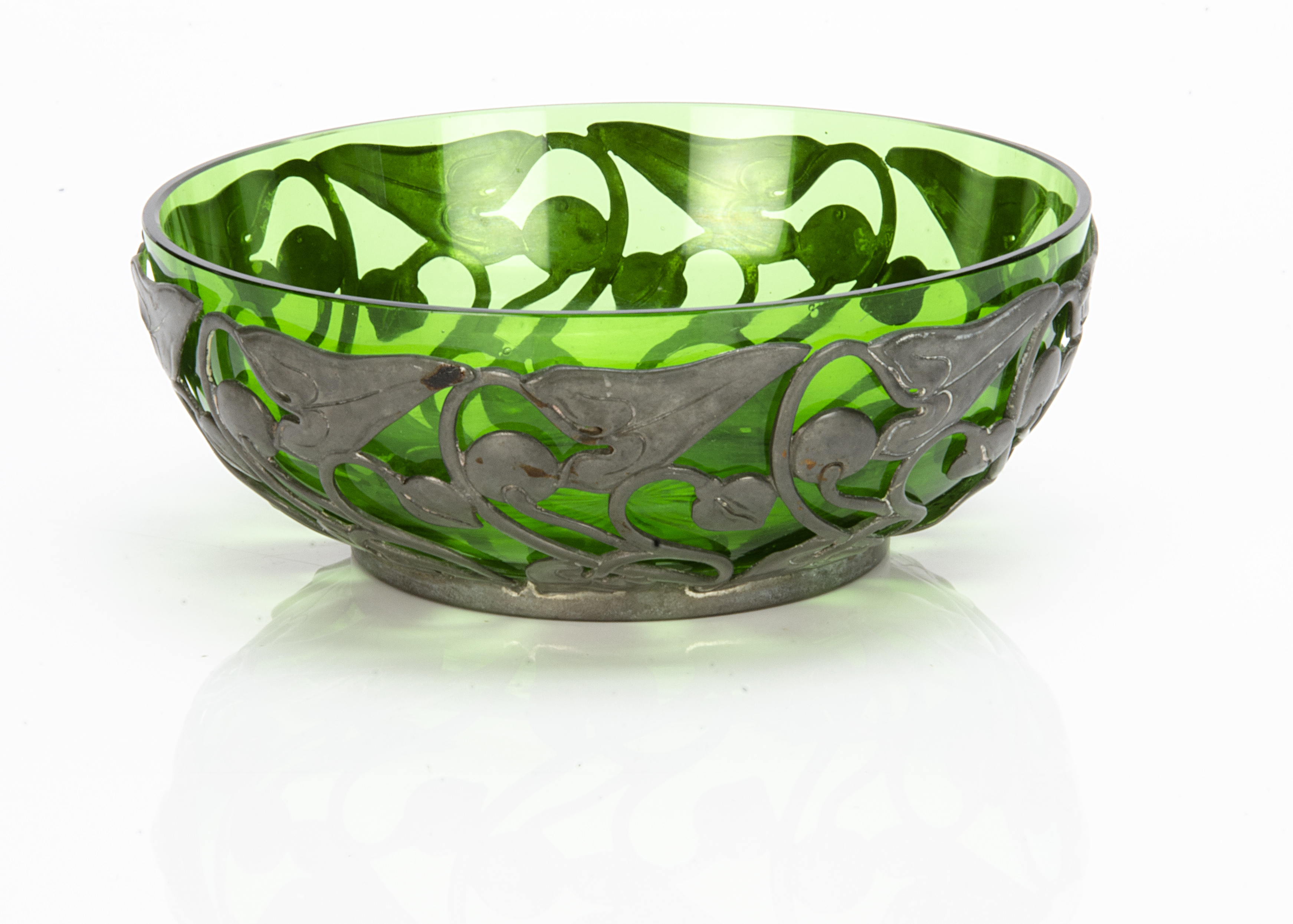 A continental Art Nouveau pewter bowl with green glass liner, the pewter bowl with all over stylised