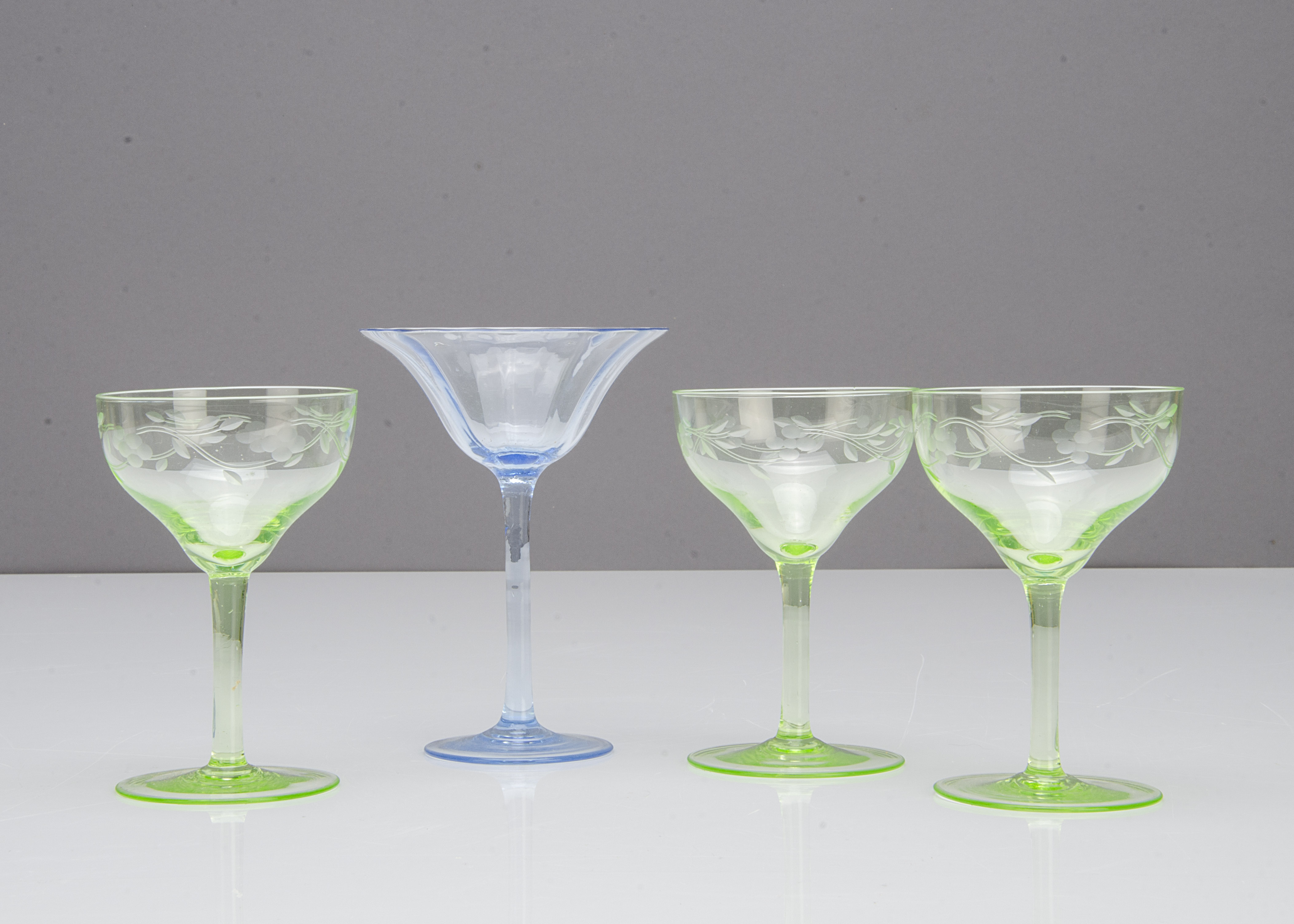 A set of three green engraved Art Nouveau liquor glasses, 10cm high together with a blue optic - Image 2 of 2