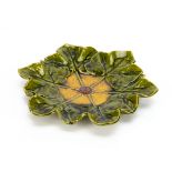 A Bretby moulded pottery dish, modelled as a wreath of leaves centred with flower head, the ochre