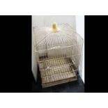 A large mid Century parrot cage, the wirework cage painted in white with simulated brass top, of