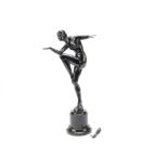 A spelter Art Deco figure, modelled as a female dancer in the Egyptian style standing on one leg