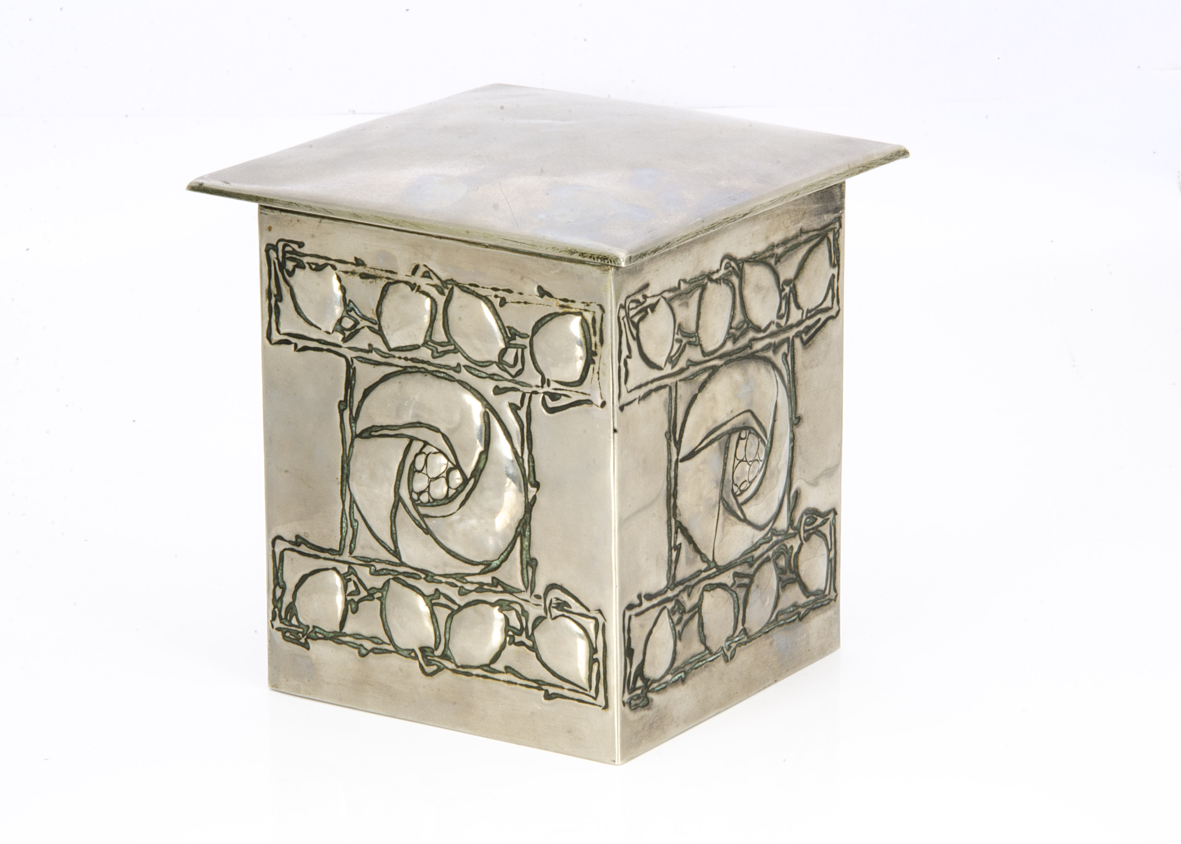 A Scottish school influenced pewter and tin biscuit box, with cushion shaped hinged lid, the