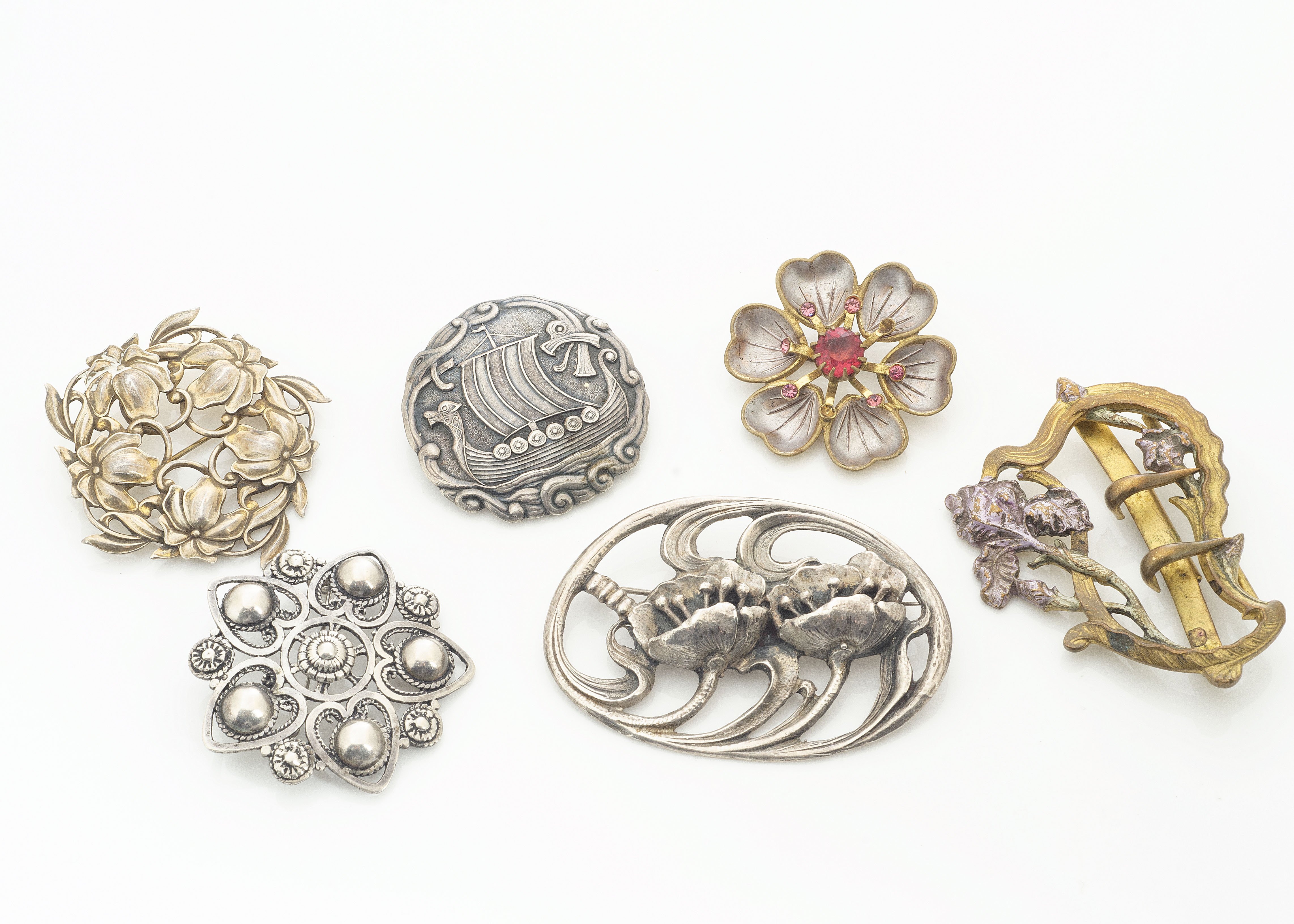 A collection of Art Nouveau and Art Nouveau style brooches, including a Norwegian example of a