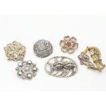 A collection of Art Nouveau and Art Nouveau style brooches, including a Norwegian example of a