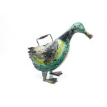A novelty watering can, in tin modelled as a duck, the two feet supporting duck's body with open
