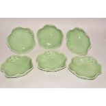 A set of six contemporary green glazed porcelain bowls, as lily leaves with moulded frog design,