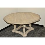 A contemporary limed oak Tudor Rose dining table, of shaped form on four large scroll cabriole