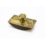 A German Art Nouveau lacquered brass desk blotter, the rectangular top of shaped outline with floral