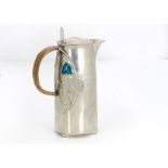 A Liberty & Co Tudric pewter and enamel hot water jug, the cylindrical body with stylised Honesty,