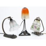Three early 20th Century table lamps, all with glass painted shades, the metal table lamps