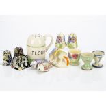 A collection of Art Deco kitchenware items, including a Kleen Kitchenware flour shaker with high