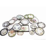 A collection of early 20th Century pottery and base metal Art Nouveau decorated coasters, teapot