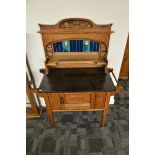 An Arts and Crafts oak tiled back marble topped washstand, the stylised blue, yellow and green tiled