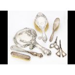 A collection of various silver backed dressing table items, comprising an Edward VII hand mirror,