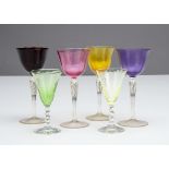 A set of four coloured glass wine glasses, the harlequin glasses with a spiral tapered stem and