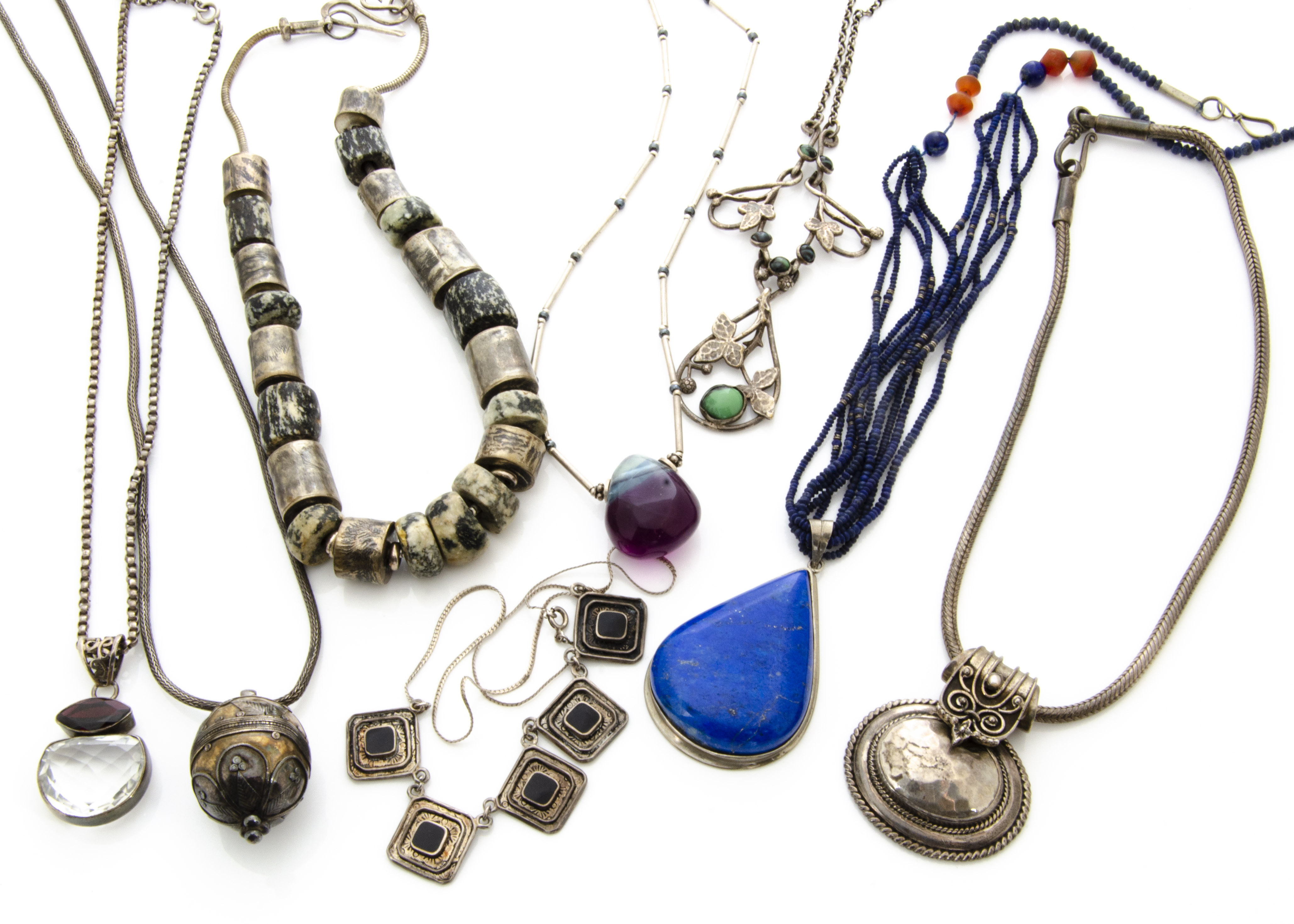 A collection of silver and white metal necklaces, comprising a simulated turquoise Art Nouveau