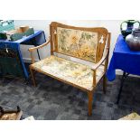 An oak Art Nouveau settle, the two seater settle with shaped back, pierced stylised floral backsplat